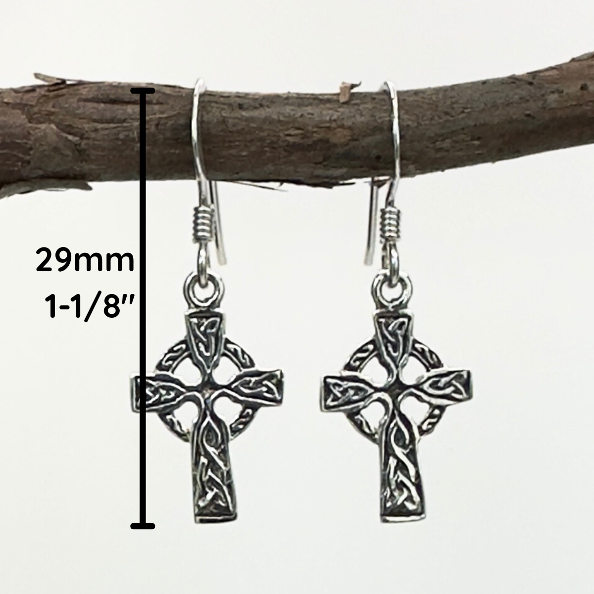 Silver Celtic cross earrings on a branch with measurements.