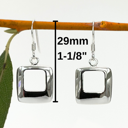 Silver square earrings on a branch with measurements indicated.