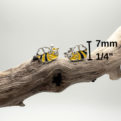 Bee-shaped earrings on a branch with measurement label