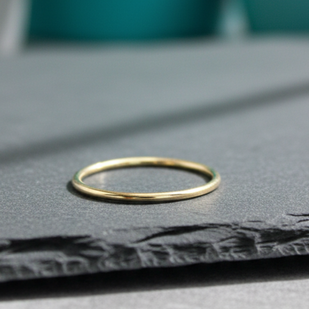 Gold ring on a textured surface with a blurred background
