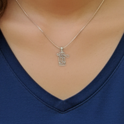 Silver necklace with a pendant worn by a person against a blue shirt background