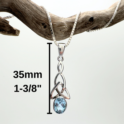Silver pendant with blue gemstone on a branch, showing size measurement.
